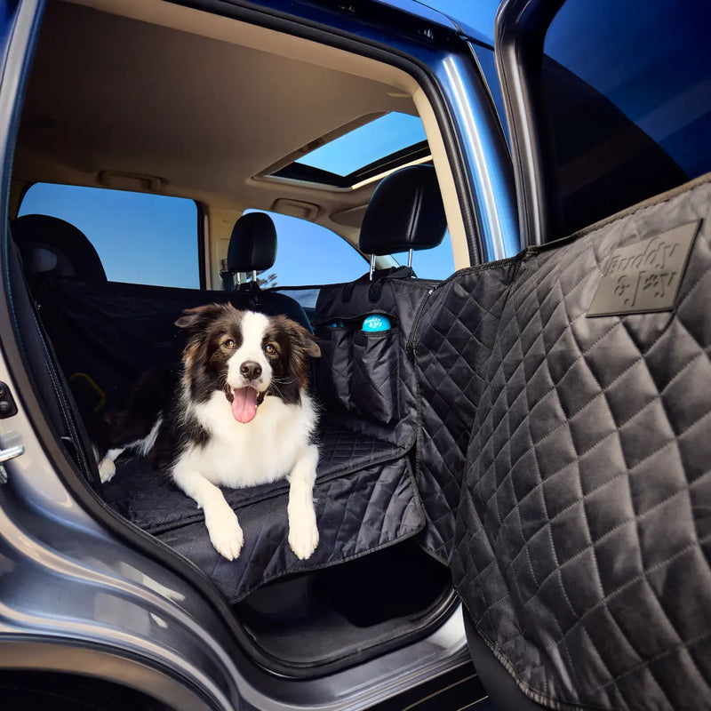 Dog laying in Buddy & Joy Hammock - demonstrating the integrated door cover, seat base, seat overhang and storage pocket. Fits next to babyseat. 